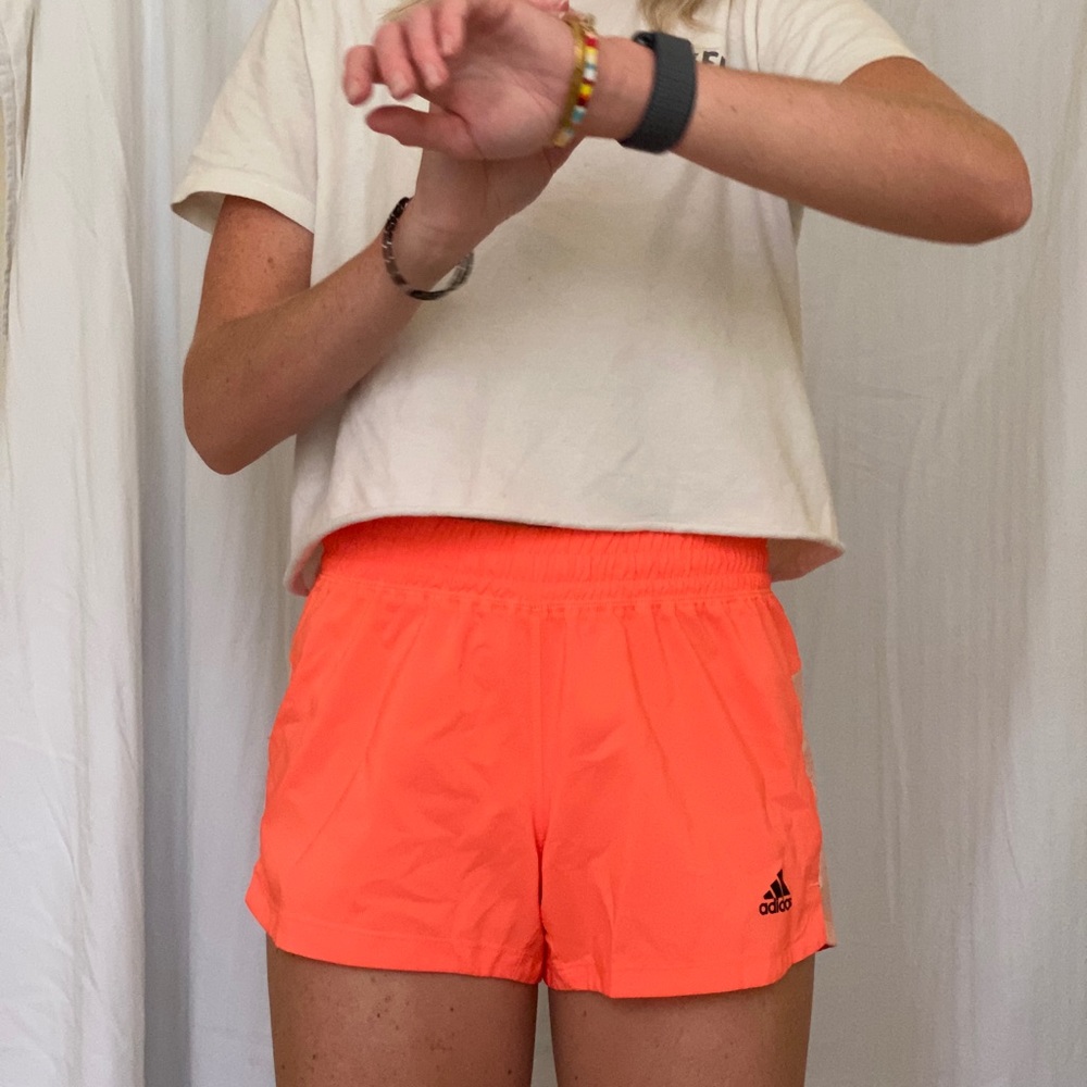 Bright orange adidas athletic shorts